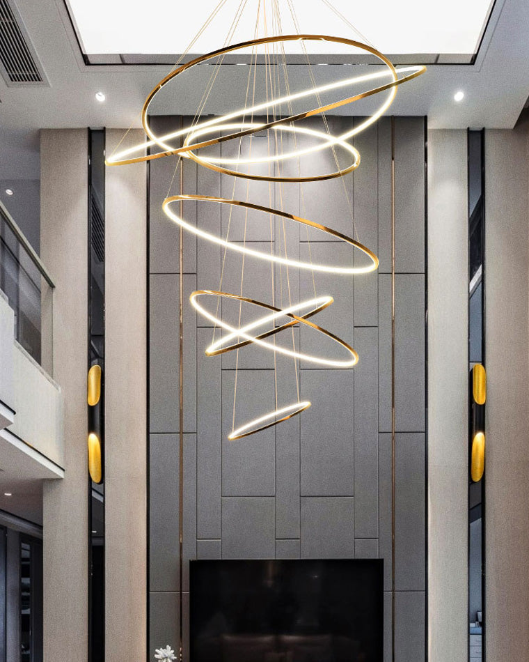 Cascading LED rings bringing layered illumination to a two-story living room, with open spacing that preserves the room’s airy scale.