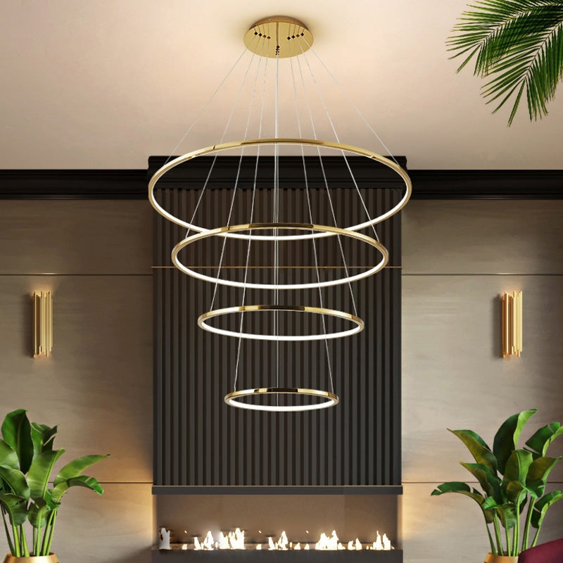 Four-ring gold chandelier above a linear fireplace, offering a balanced option for foyers that need impact without an extra-long drop.