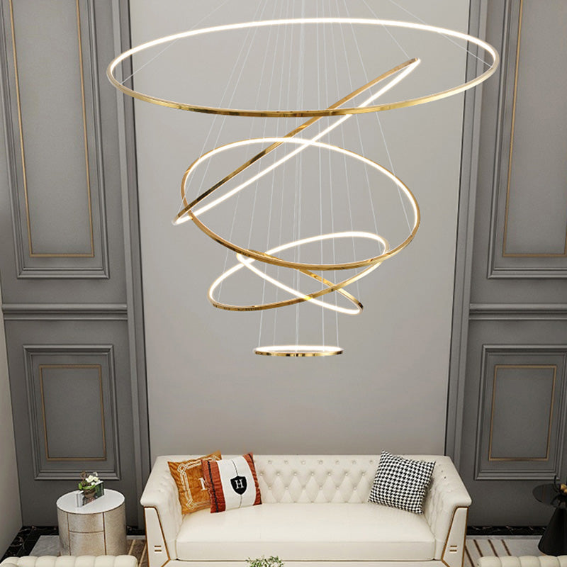 Six-ring gold chandelier illuminating a paneled lounge, providing a fuller vertical presence for generously proportioned ceilings.