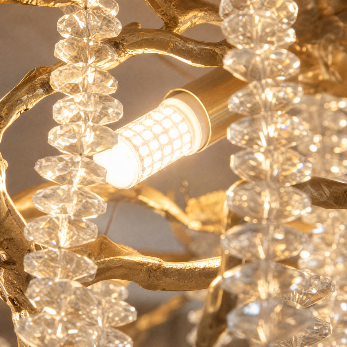 A Blush gold metal branch chandelier with cascading crystal beads suspended in a rainfall arrangement.