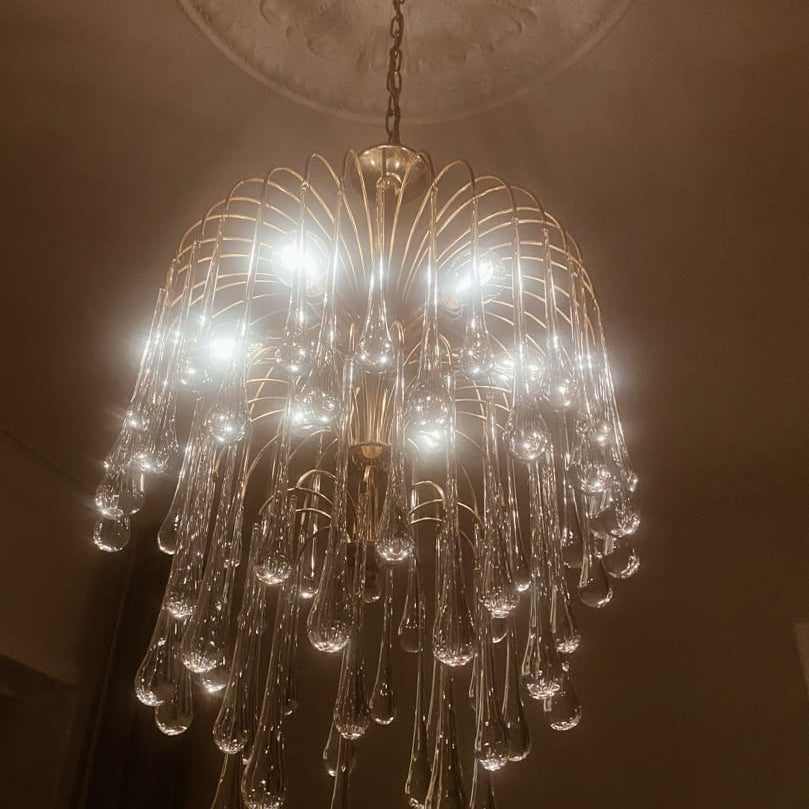 Chandelier hanging from a ceiling with a dark background
