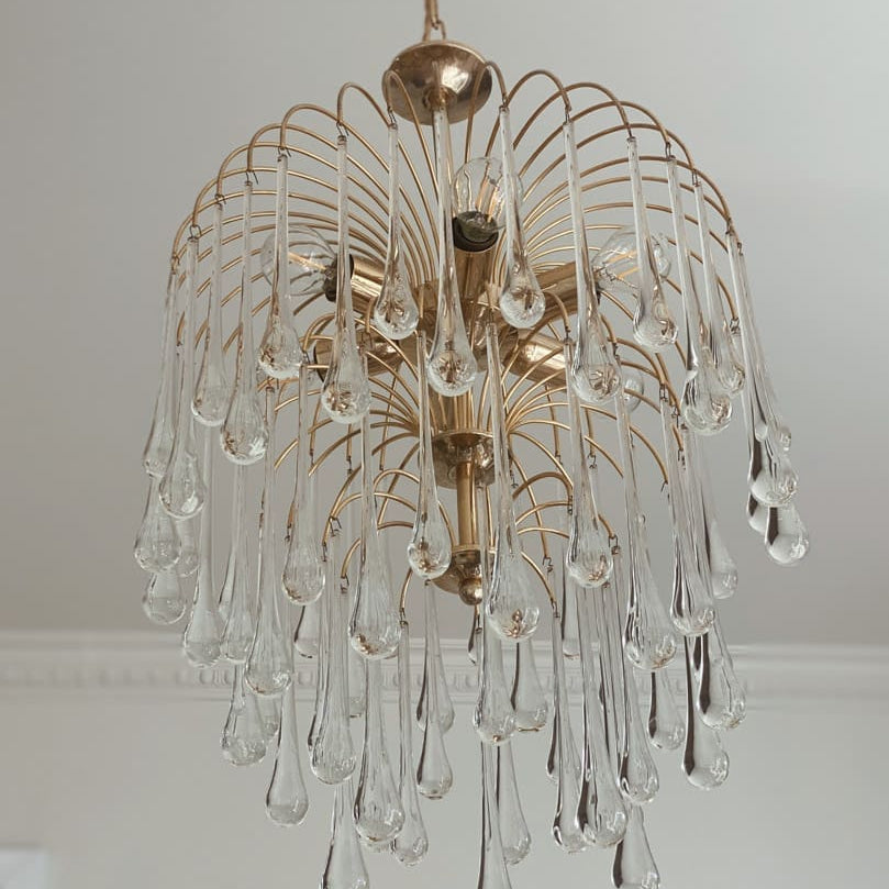 Chandelier with glass droplet design on a white ceiling