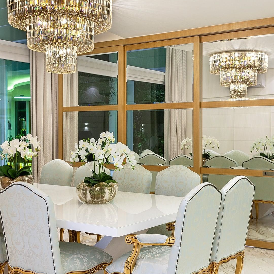 Dining room with a chandelier, table, and chairs.