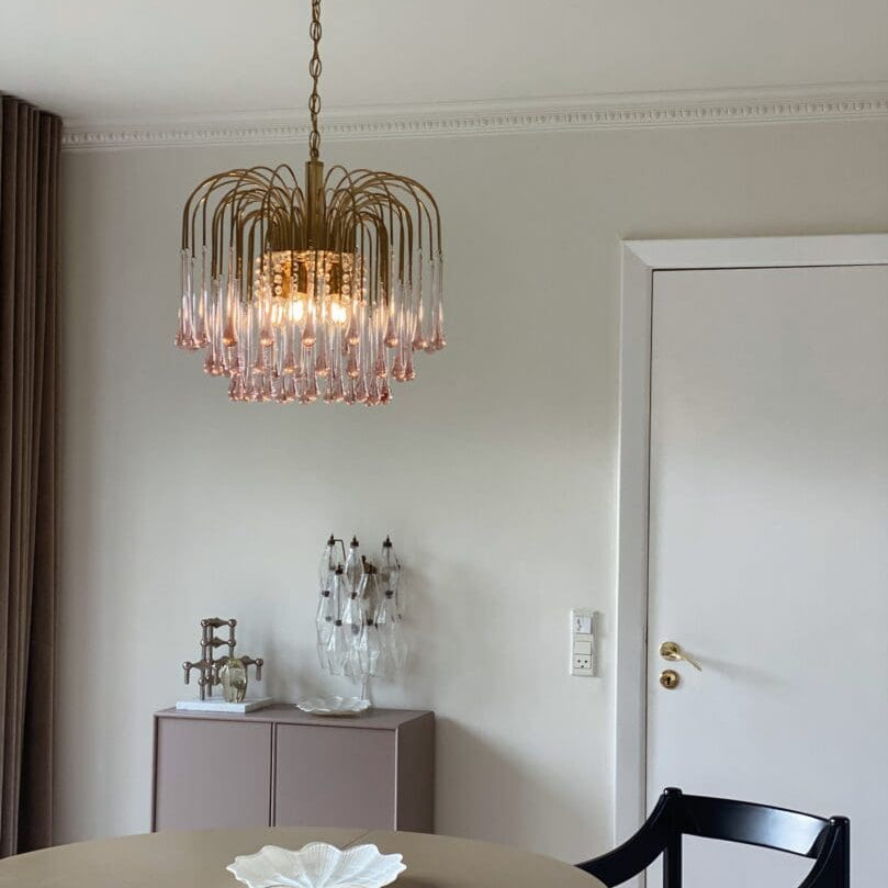 Dining room with a chandelier, table, and chairs.