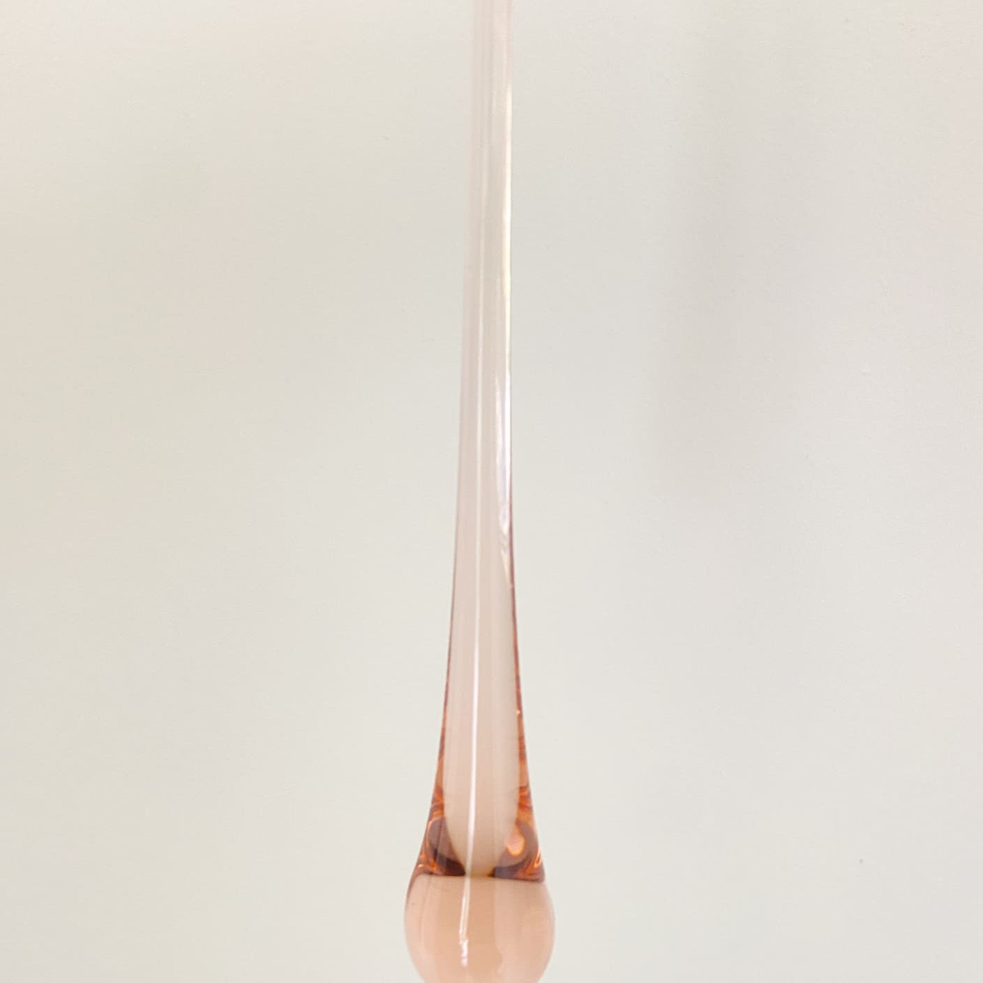 Rose gold pendant on a white background