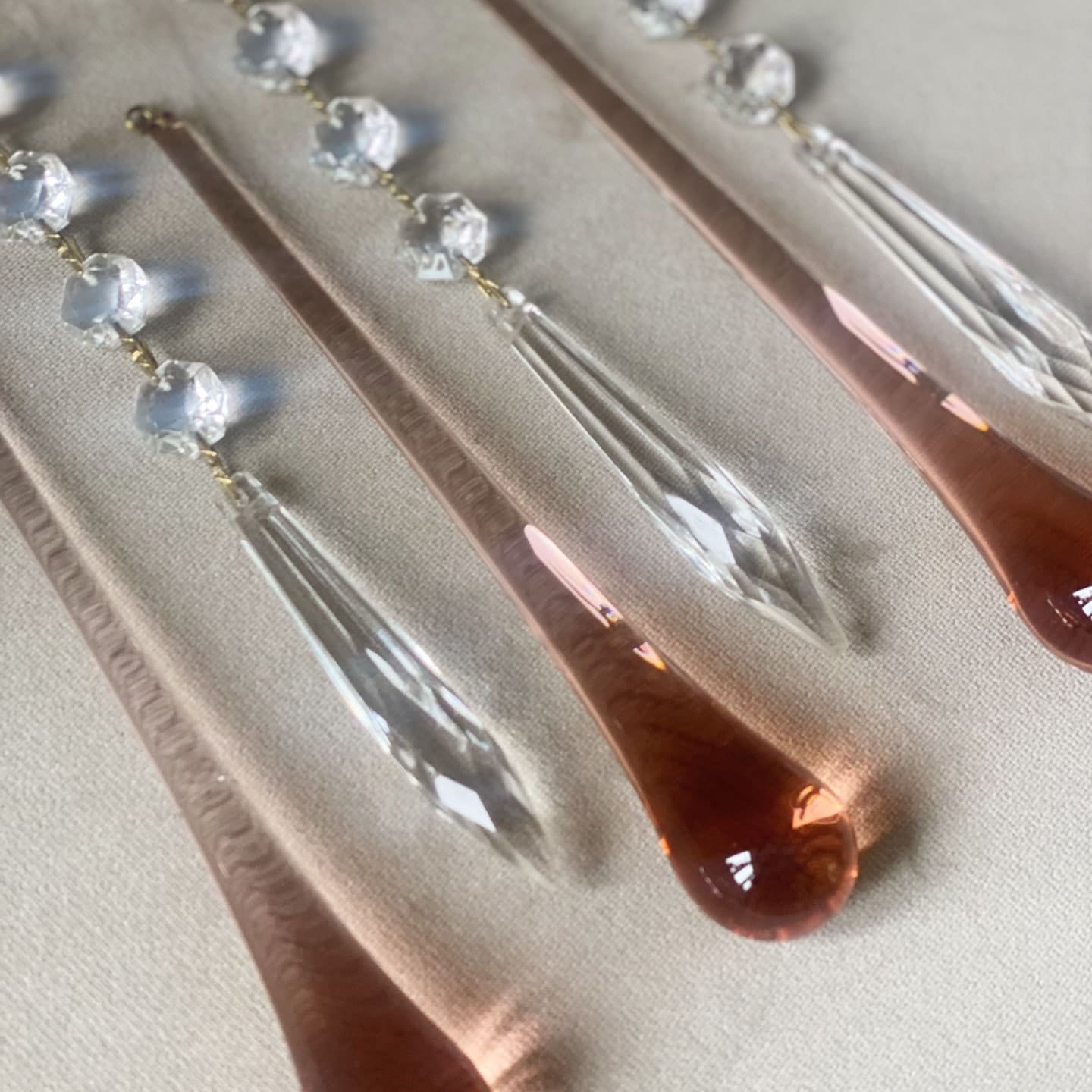 Rose gold hair pins with clear crystal elements on a light background