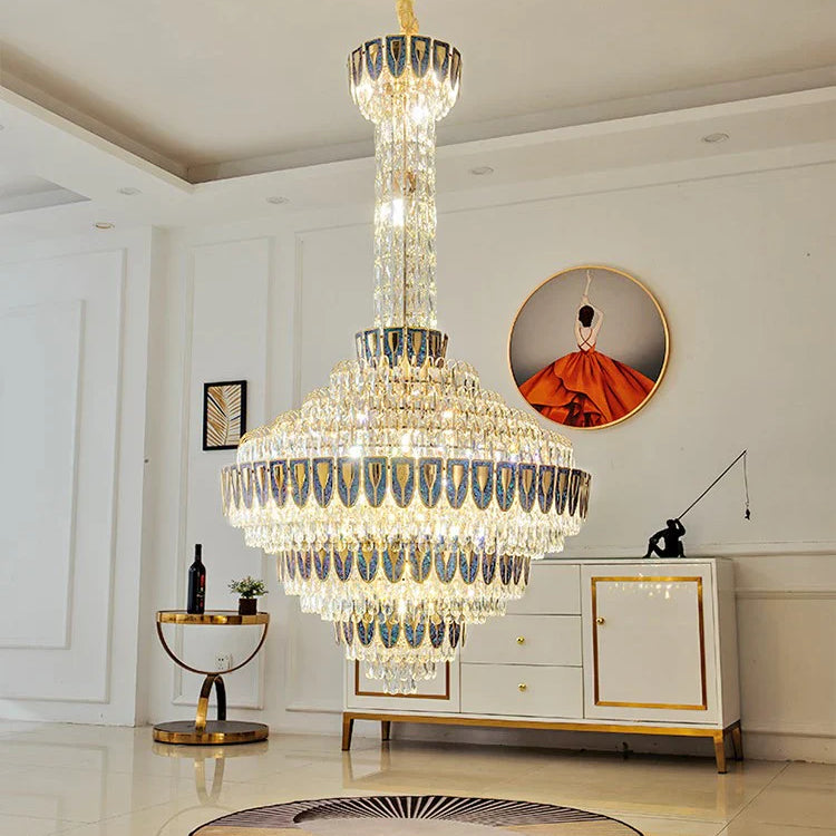Chandelier casting warm light over polished marble stairs