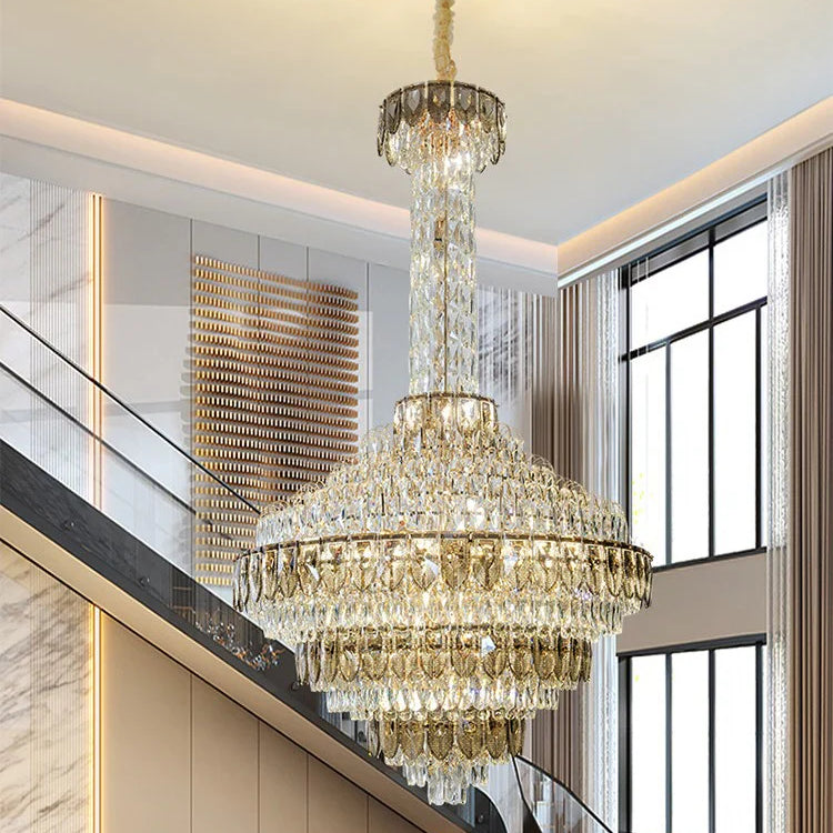 Luxury chandelier installation in high-ceiling entrance area