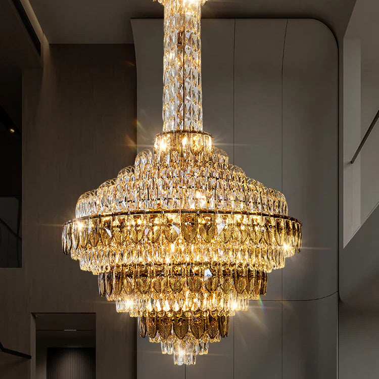 Large chandelier illuminating a high ceiling hallway interior