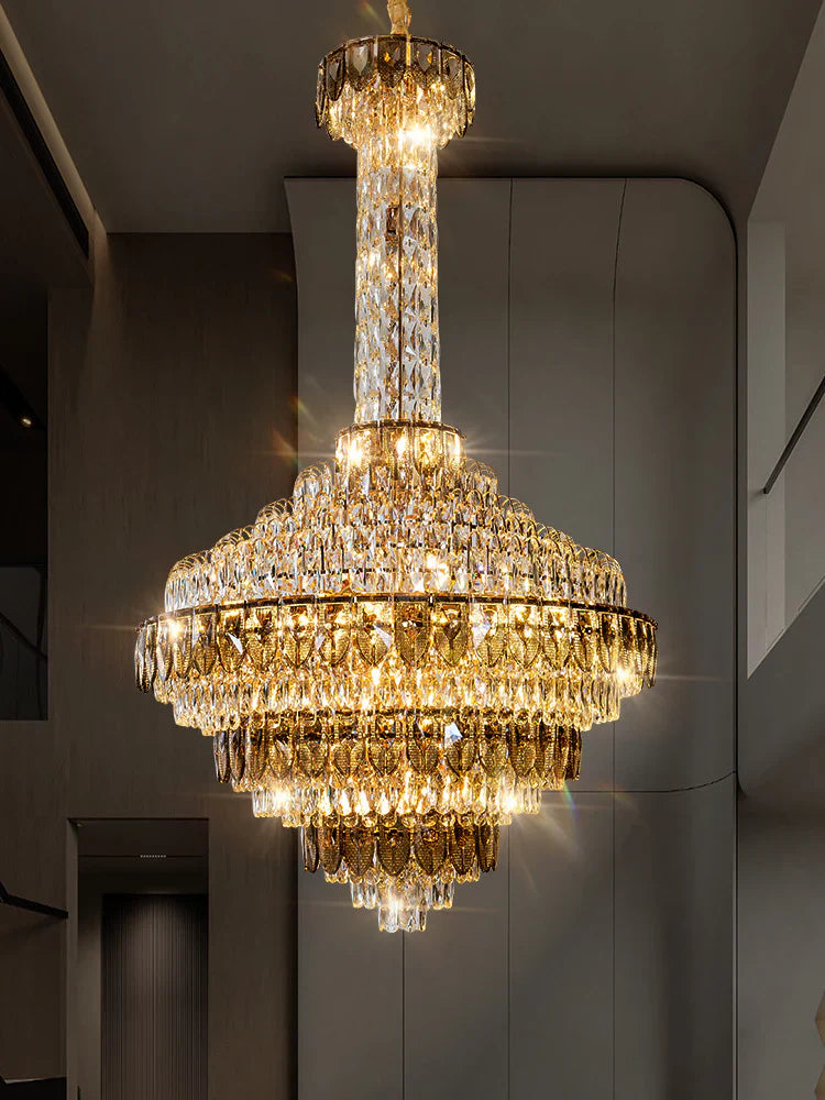 Large chandelier illuminating a high ceiling hallway interior