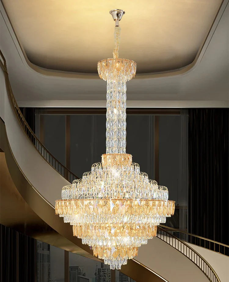 Luxury chandelier installation in high-ceiling entrance area