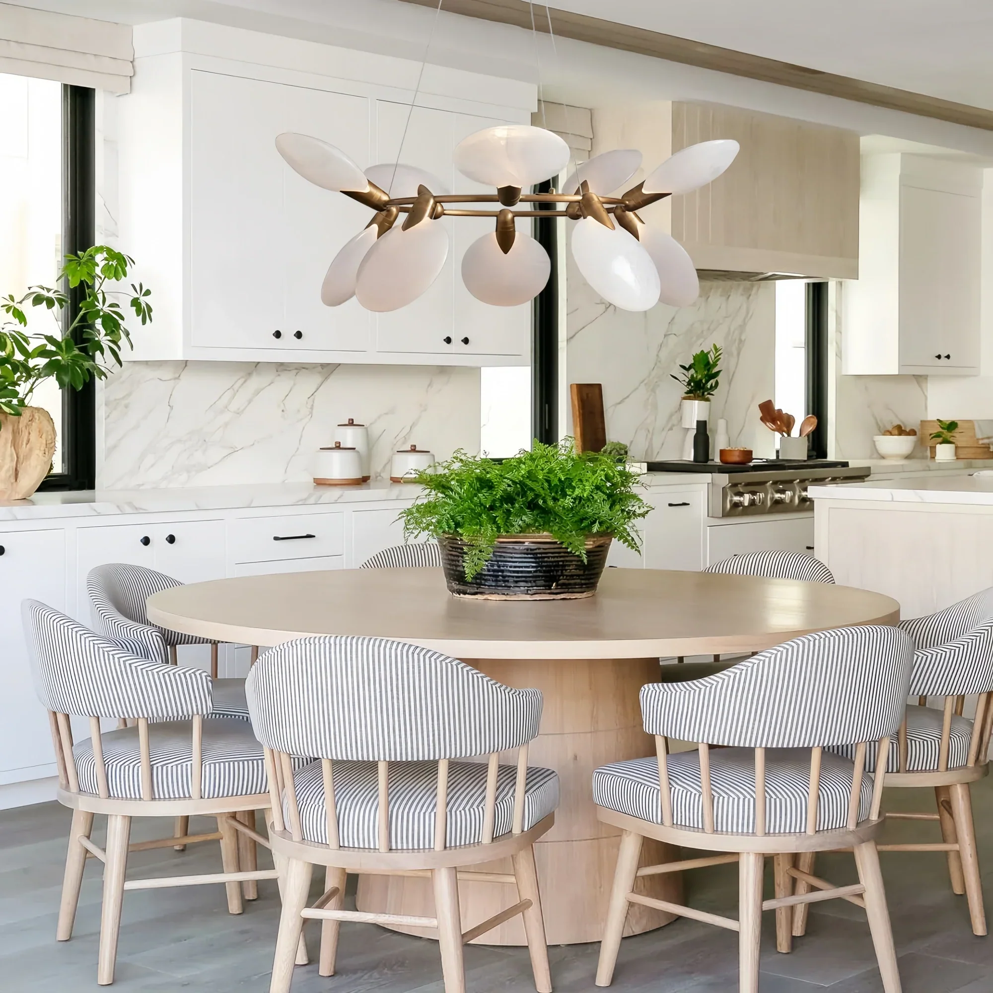 Dining room illuminated by Lyla Halo Chandelier with elegant circular design