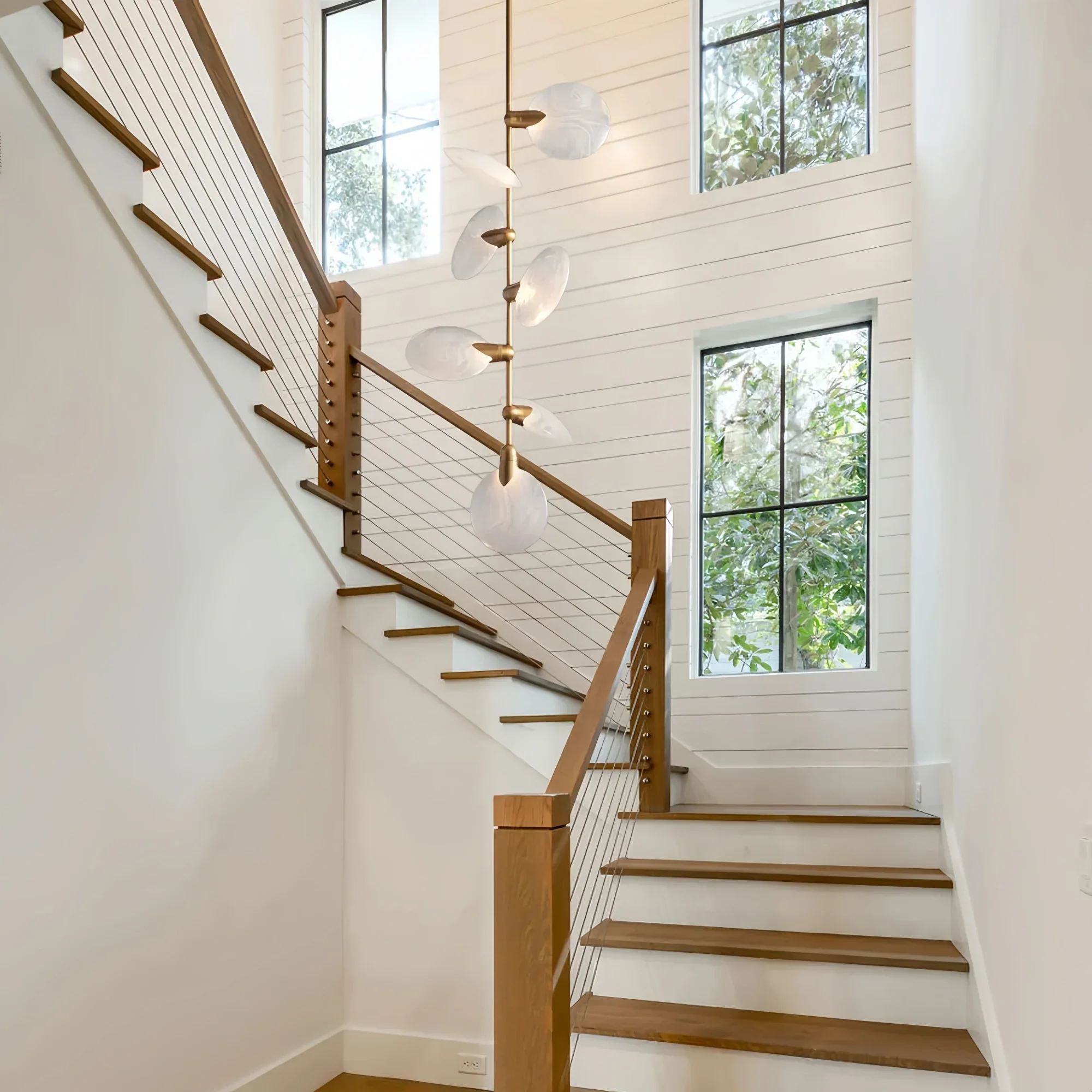 Modern staircase pendant lighting featuring Lyla Pendant in brushed brass