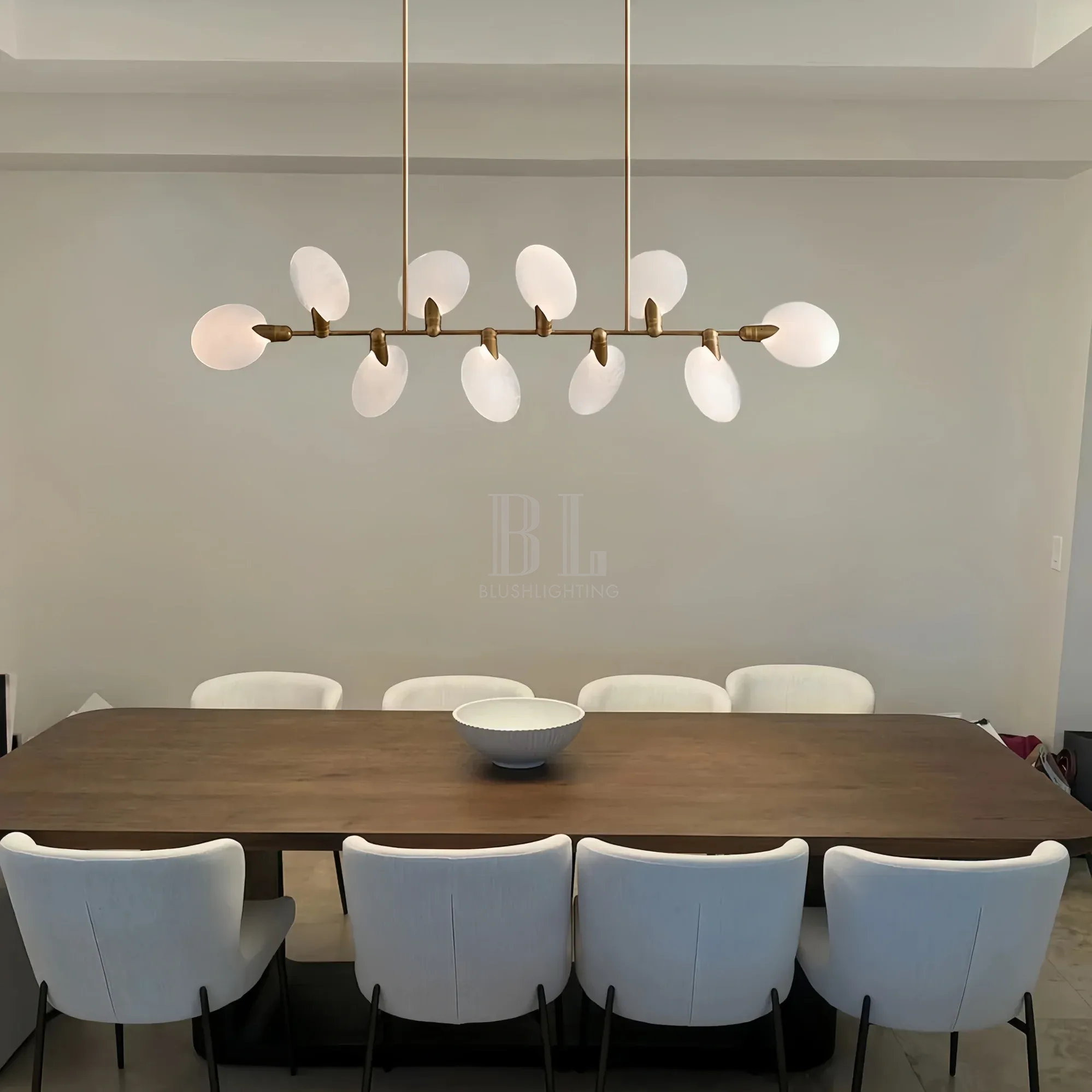 Modern living space illuminated by Lyla Linear Chandelier in linear design