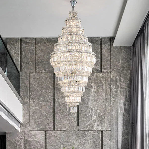 Luxurious chandelier hanging in a room with a stone wall.