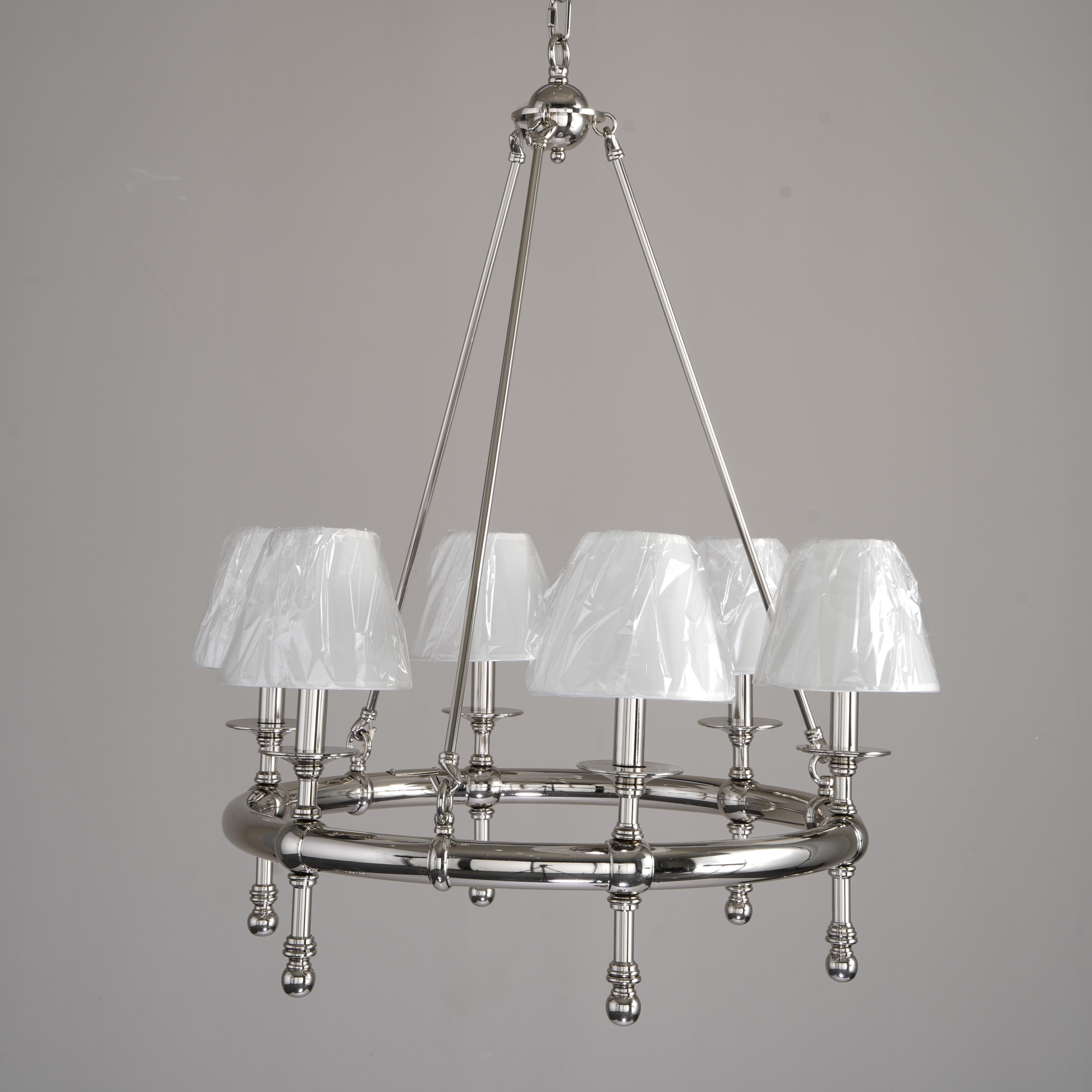 Chandelier with white lampshades on a gray background