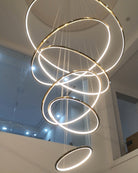 Close upward view of the illuminated rings and slender cables, showing bright, continuous LED light without bulky lamp holders.