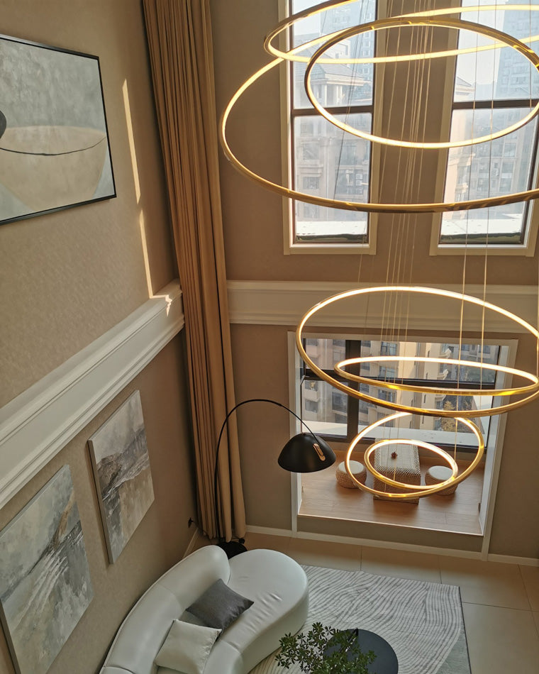 Top-down view of a warm gold entryway chandelier, showing how layered rings enrich the foyer from both upper and lower floors.