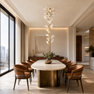 A brass branch-inspired chandelier featuring cascading frosted leaf-shaped glass shades hanging vertically.