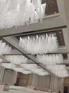 https://cdn.shopify.com/s/files/1/0554/8562/8591/files/Modern_Layered_Clear_Textured_Glass_Panel_Ceiling_Light_for_Hotel_Lobby.jpg?v=1774927063