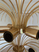 Close-up of a gold chandelier with multiple arms.