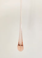 Rose gold pendant on a white background