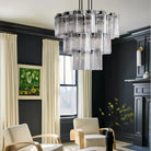 Modern living room with a chandelier, armchairs, and decorative elements.