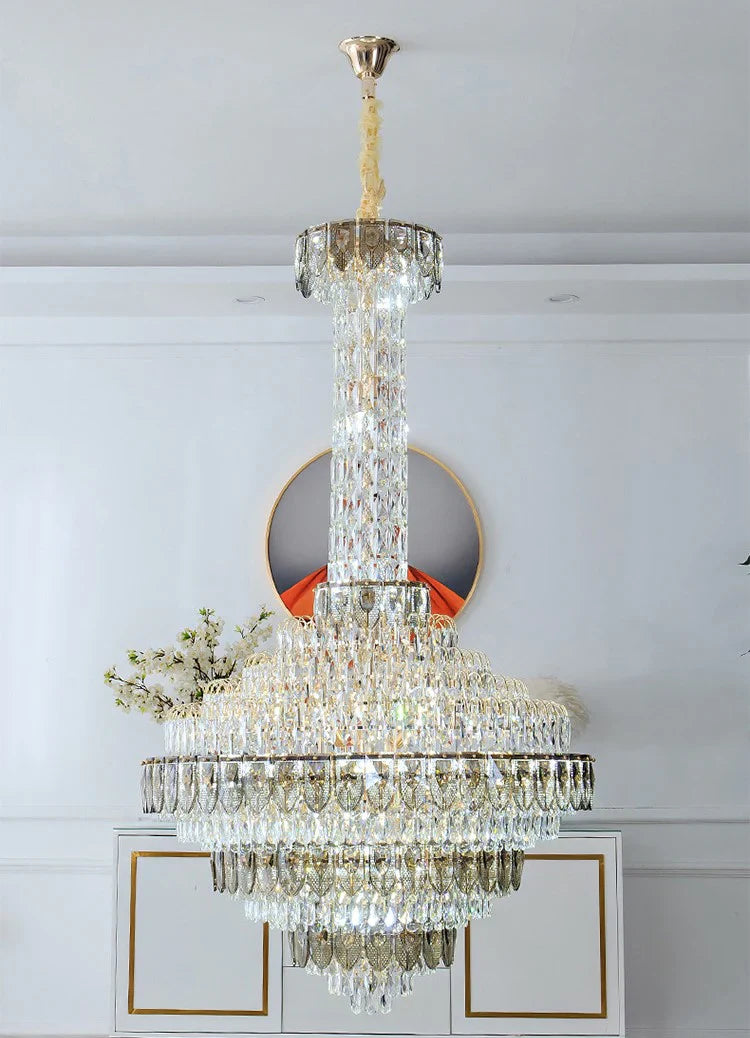 Oversized chandelier creating a dramatic staircase lighting effect