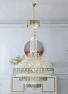 Oversized chandelier creating a dramatic staircase lighting effect