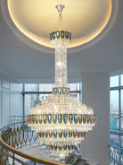 Luxury crystal chandelier hanging in a double-height staircase space