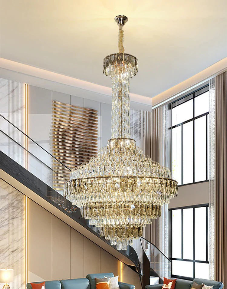 Luxury chandelier installation in high-ceiling entrance area