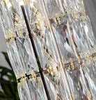 Chandelier crystal pieces reflecting warm light