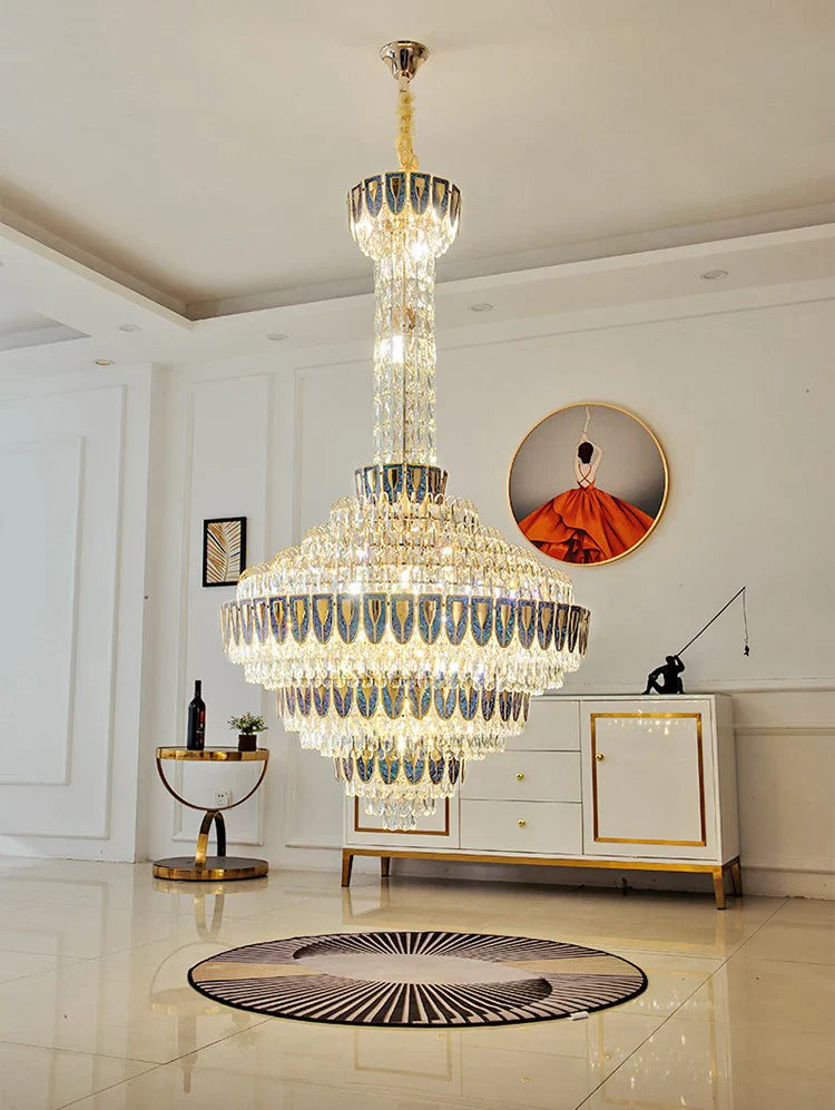 Chandelier casting warm light over polished marble stairs