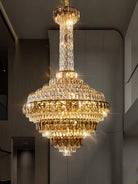 Large chandelier illuminating a high ceiling hallway interior