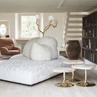 Side view of sculptural brass floor lamp with three light heads