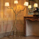 Ines brass floor lamp displayed beside luxury seating