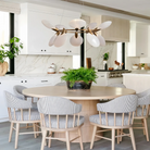 Dining room illuminated by Lyla Halo Chandelier with elegant circular design