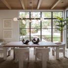 Lyla Linear Chandelier 74 inch modern linear chandelier hanging above dining table