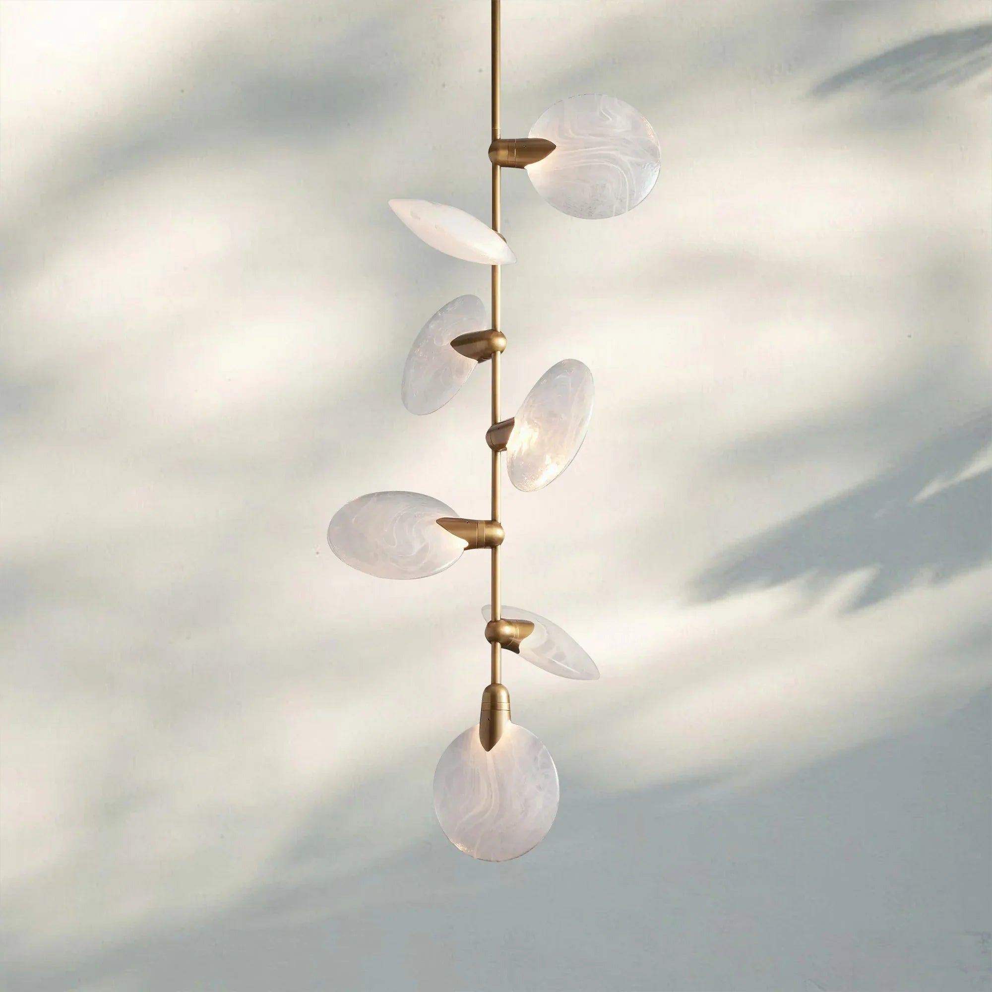 Close-up of Lyla Pendant with natural alabaster texture and gold details