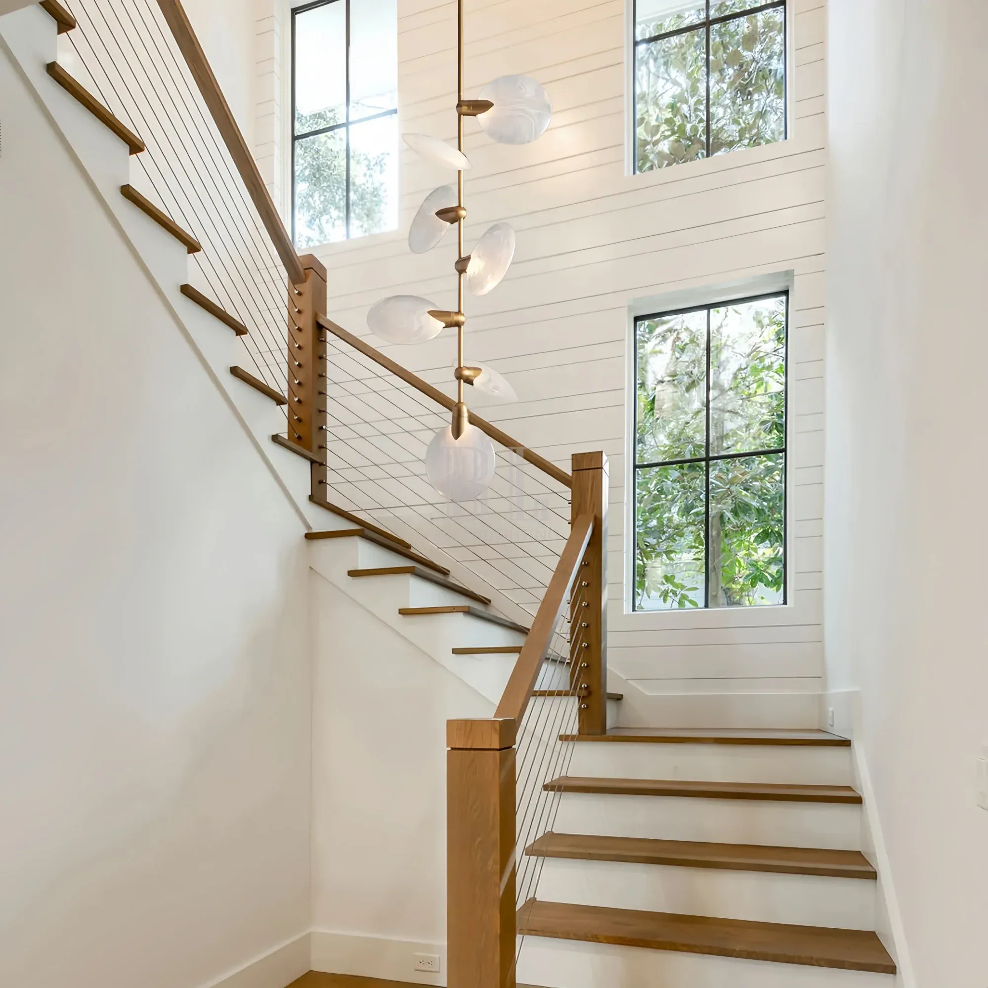 Modern staircase pendant lighting featuring Lyla Pendant in brushed brass