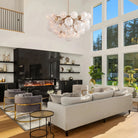 Modern living room with a white sofa, gray chairs, and a large window.